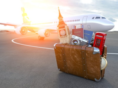 leaving uk plane with suitcase packed in front including uk iconic items