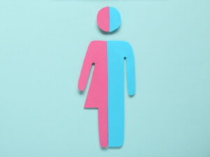 man woman signs spliced together half blue half pink