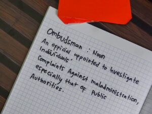 ombudsman definied handwriting on note paper