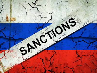 russia flag cracked with sanctions written on a banner across