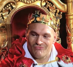 tyson fury dressed as a king on a throne