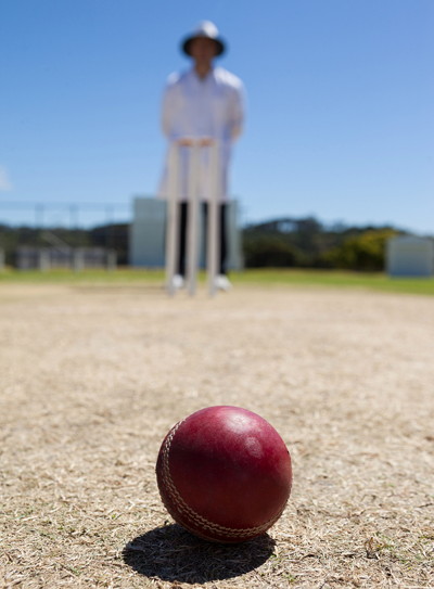 umpire stood over a cricket ball