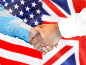 us uk handshake with flags in the background