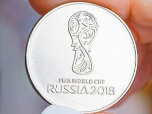 world cup coin between two fingers